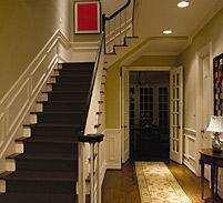 residential hallway and staircase with lights on