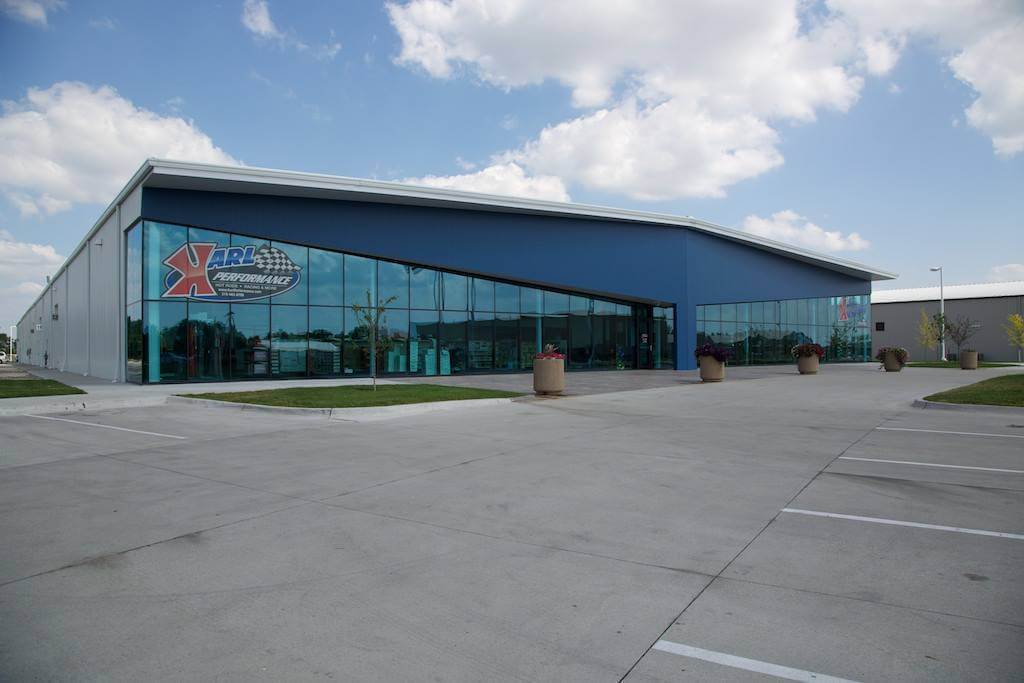 exterior shot of glass Karl Performance building with blue sky and clouds behind